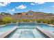 Beautiful pool features integrated hot tub, water feature, and privacy wall with mountain views at 3131 Reverence Heights Ln, Las Vegas, NV 89138