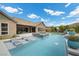 Captivating backyard oasis with swimming pool and integrated sun loungers, set for outdoor entertaining at 3131 Reverence Heights Ln, Las Vegas, NV 89138