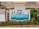 Aerial view of a modern backyard featuring a sleek pool, spa, lounge chairs, and a cozy fire pit area at 3131 Reverence Heights Ln, Las Vegas, NV 89138