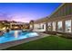 Gorgeous pool with spa, water features, outdoor kitchen, and lush landscaping for outdoor enjoyment at 3131 Reverence Heights Ln, Las Vegas, NV 89138