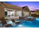 Backyard featuring a sparkling pool, spa, and outdoor lounge areas, perfect for leisure at 3131 Reverence Heights Ln, Las Vegas, NV 89138