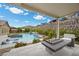 Inviting backyard pool with lounge chairs, water feature, and comfortable seating area with a fire pit at 3131 Reverence Heights Ln, Las Vegas, NV 89138