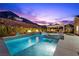 Inviting pool with water features, spa, and outdoor kitchen, perfect for gatherings and relaxation at 3131 Reverence Heights Ln, Las Vegas, NV 89138