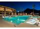 Inviting pool area with comfortable lounge chairs, palm trees, and ambient lighting, creating a relaxing and luxurious oasis at 3131 Reverence Heights Ln, Las Vegas, NV 89138