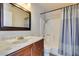 Comfortable bathroom featuring a shower with tub and a vanity with a dark wood cabinet at 3150 Soft Breezes Dr # 2030, Las Vegas, NV 89128