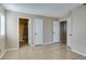 Bright bedroom with tile flooring, multiple closets, and a view of a nearby bathroom at 3150 Soft Breezes Dr # 2030, Las Vegas, NV 89128