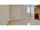 Neutral bedroom with tile floors, bathroom access, and bright window with white shutters at 3150 Soft Breezes Dr # 2030, Las Vegas, NV 89128