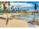 Community pool with a beach entrance, lifeguard tower, clear skies, and many palm trees at 3150 Soft Breezes Dr # 2030, Las Vegas, NV 89128