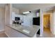 Open concept kitchen with stone countertops, white cabinets, and modern fixtures at 3150 Soft Breezes Dr # 2030, Las Vegas, NV 89128