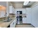 Functional kitchen with stone countertops, stainless steel appliances and white cabinets at 3150 Soft Breezes Dr # 2030, Las Vegas, NV 89128