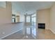 Open living room with tile floors, a fireplace, and access to outdoor space at 3150 Soft Breezes Dr # 2030, Las Vegas, NV 89128