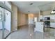 Open floor plan with tile floors connecting the living room and kitchen area at 3150 Soft Breezes Dr # 2030, Las Vegas, NV 89128