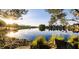 Scenic view of a tranquil pond reflecting the surrounding trees and houses on a sunny day at 3150 Soft Breezes Dr # 2030, Las Vegas, NV 89128