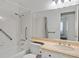 Bright bathroom with a shower-tub combination, accessibility handrails, and a large mirror above the sink at 349 Clayton St, Henderson, NV 89074