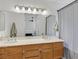 Spacious bathroom boasts double sinks, wood cabinets, and a large mirror with great lighting at 349 Clayton St, Henderson, NV 89074
