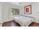 Bright bedroom features a comfortable queen bed, wood floors, and natural light from the window at 349 Clayton St, Henderson, NV 89074