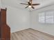 Well-lit bedroom with laminate floors, a ceiling fan, and a large window with natural light at 349 Clayton St, Henderson, NV 89074
