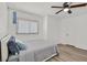 A comfy bedroom with cozy interior design, a ceiling fan, a window, and wooden floor at 349 Clayton St, Henderson, NV 89074