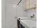 The functional laundry room includes a modern washer and dryer set with storage cabinets above at 349 Clayton St, Henderson, NV 89074
