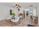 Bright living room with tile floors, two chairs, and an open layout into the kitchen at 349 Clayton St, Henderson, NV 89074