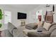 Comfortable living room featuring plush sectional seating and natural lighting at 349 Clayton St, Henderson, NV 89074