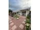 Landscaped backyard featuring a putting green, a covered patio, and meticulous landscaping at 3562 Driving Range St, Las Vegas, NV 89122