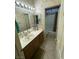 Bathroom with tiled floors, a vanity, and a combination bathtub and shower at 3562 Driving Range St, Las Vegas, NV 89122