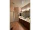 Bathroom featuring a double vanity, tile flooring, and mirrored wall at 3562 Driving Range St, Las Vegas, NV 89122