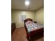 Bedroom featuring wood flooring, large window with blinds and a bed at 3562 Driving Range St, Las Vegas, NV 89122