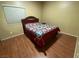 Bedroom with hardwood floors and a Queen bed with colorful quilt at 3562 Driving Range St, Las Vegas, NV 89122