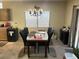 A view of the dining room with a large table and view into the kitchen at 3562 Driving Range St, Las Vegas, NV 89122