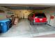 Organized garage with shelving, storage cabinets, and a parked red Jeep SUV at 3562 Driving Range St, Las Vegas, NV 89122