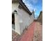 Home's side yard with red brick pathway, side gate, and stucco exterior at 3562 Driving Range St, Las Vegas, NV 89122
