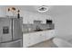 Modern kitchen featuring white cabinets, stainless steel appliances, and stylish backsplash at 3727 Hazelwood St # 12, Las Vegas, NV 89119
