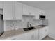 Updated kitchen featuring white cabinetry, sleek countertops, and modern stainless steel appliances at 3727 Hazelwood St # 12, Las Vegas, NV 89119