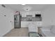 Bright kitchen with white cabinets, stainless steel refrigerator, and light wood-look flooring at 3727 Hazelwood St # 12, Las Vegas, NV 89119