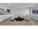 Open living room with modern furniture, white walls, and kitchen view at 3727 Hazelwood St # 12, Las Vegas, NV 89119