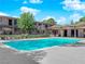 Community pool surrounded by lush landscaping and multi-story apartment buildings at 3727 Hazelwood St # 12, Las Vegas, NV 89119