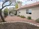 Backyard featuring an outdoor dining set, a patio, trees, and minimal landscaping at 3816 Sunking St, Las Vegas, NV 89130