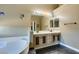Primary bathroom features a soaking tub, double sinks, and lots of lighting at 3816 Sunking St, Las Vegas, NV 89130