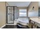 Bright bathroom featuring a soaking tub, glass shower, and neutral wall paint at 3816 Sunking St, Las Vegas, NV 89130