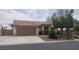 Charming single-story home featuring a tile roof, an attached two-car garage and a well-maintained front yard at 3816 Sunking St, Las Vegas, NV 89130