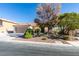 Beautifully landscaped front yard with mature trees and desert-friendly plants enhancing the curb appeal at 3816 Sunking St, Las Vegas, NV 89130