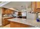 A kitchen featuring warm cabinets, granite countertops, and black appliances at 3816 Sunking St, Las Vegas, NV 89130