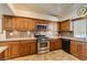 A kitchen featuring warm cabinets, granite countertops, and stainless appliances at 3816 Sunking St, Las Vegas, NV 89130