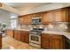 A kitchen featuring warm cabinets, granite countertops, and stainless appliances at 3816 Sunking St, Las Vegas, NV 89130