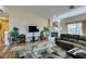 Open living room with vaulted ceilings, fireplace, and a comfortable sofa at 3816 Sunking St, Las Vegas, NV 89130