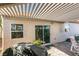 Sliding door to a covered patio with an outdoor dining set and backyard view at 3816 Sunking St, Las Vegas, NV 89130
