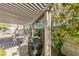 Covered patio featuring an outdoor grill, a dining table, and a cozy seating area at 3816 Sunking St, Las Vegas, NV 89130