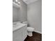 Bathroom featuring a sink and toilet with dark wood floors at 4339 Spencer St # 15, Las Vegas, NV 89119